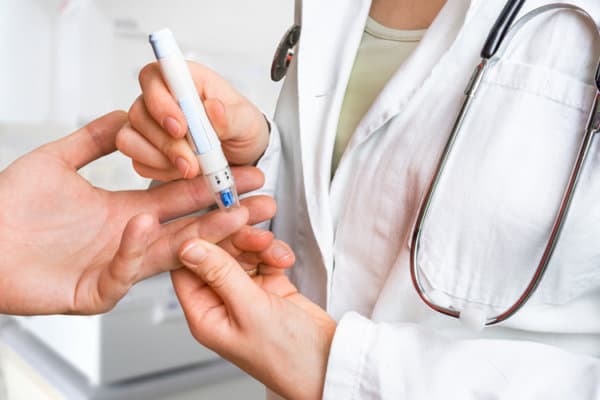 Measuring blood sugar on finger &#8211; diabetes concept